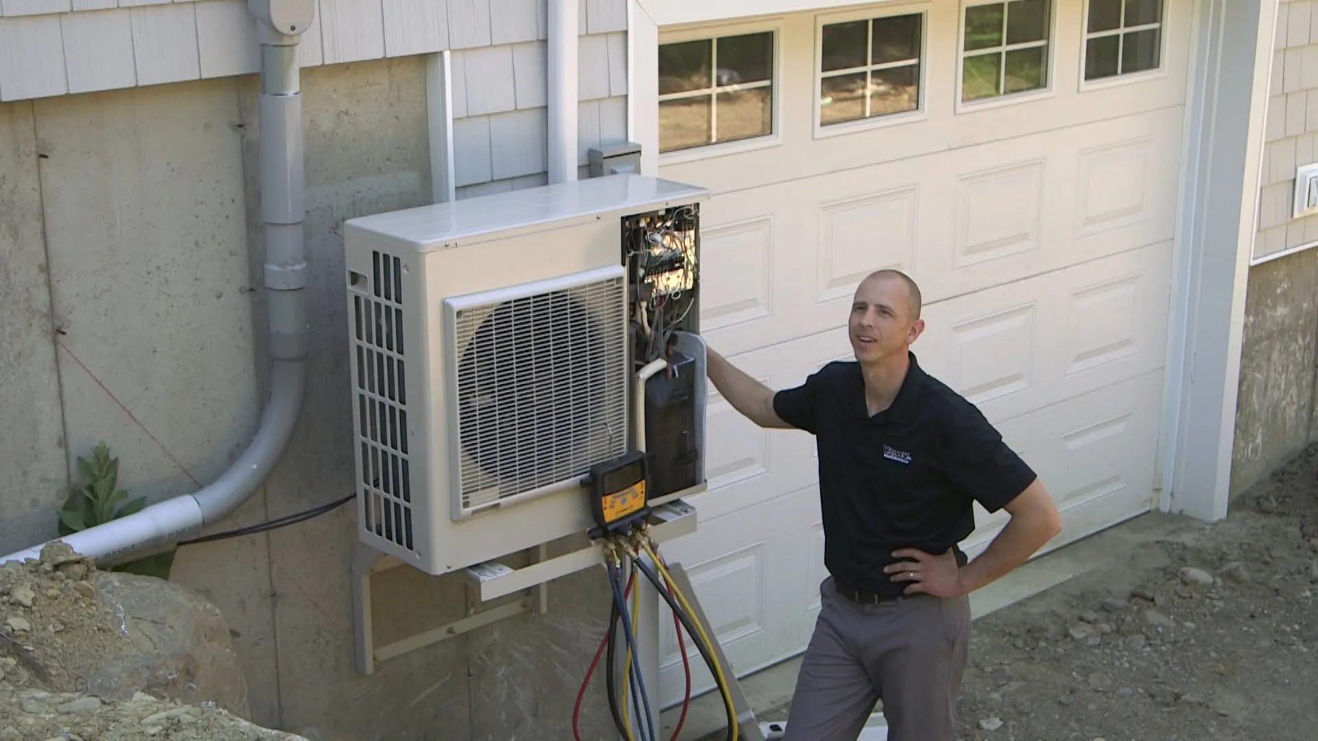 Valley Home Services technician mounting the ductless mini-split outdoor condenser
