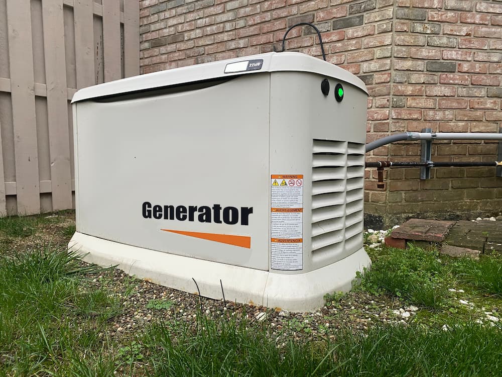 Home standby generator on the grass, promoting maintenance services and signs you need to replace your generator.